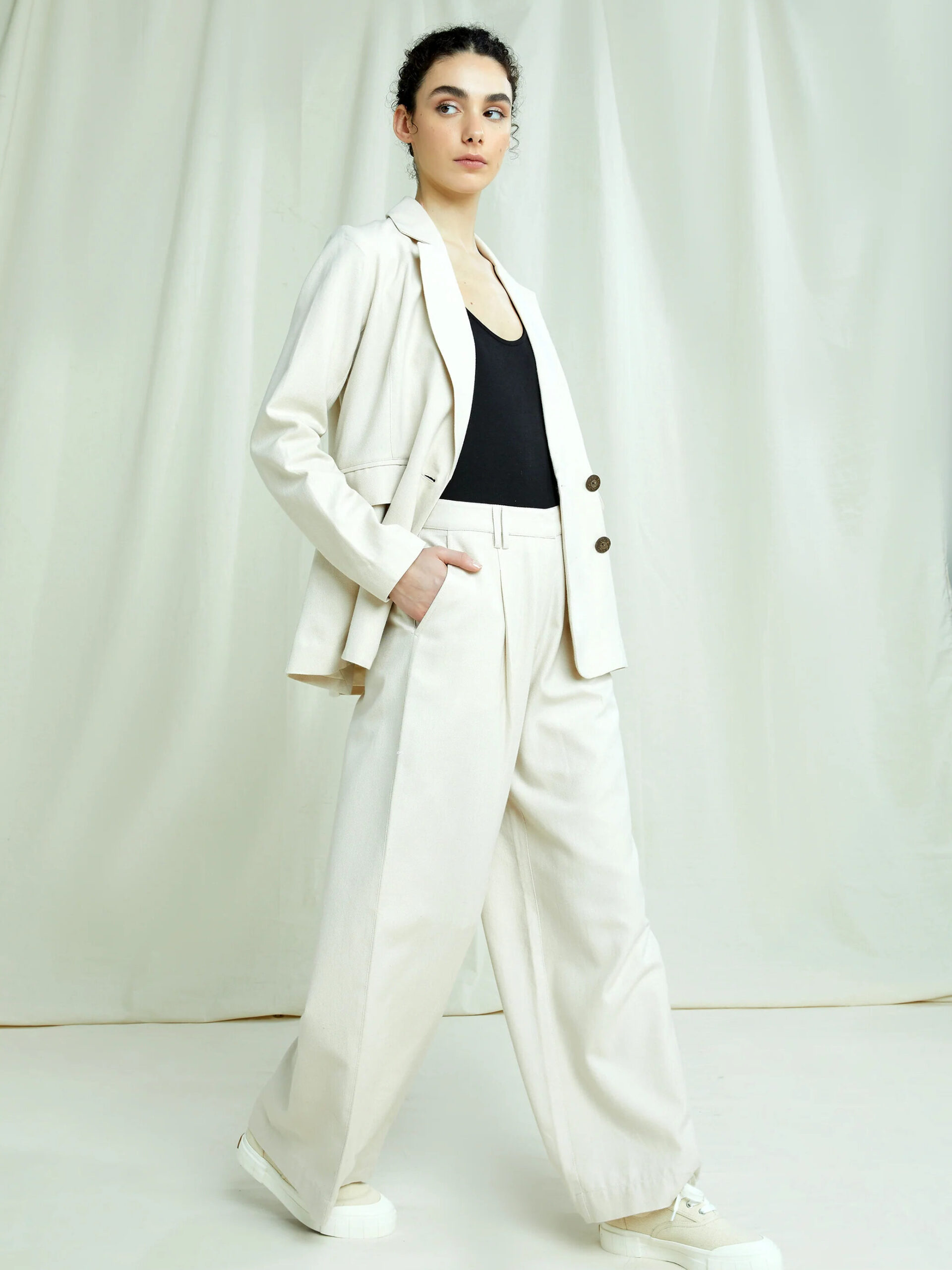 Model wearing People Tree's Naira Blazer and matching pants in cream.