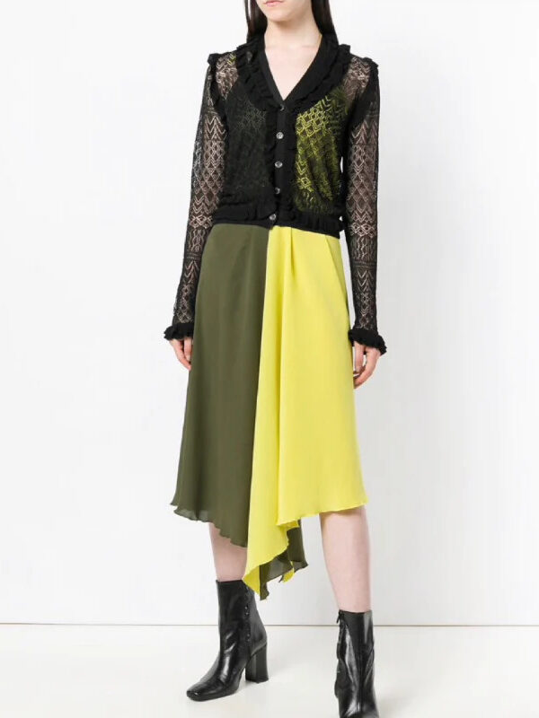 A model wearing a split green and yellow mid length dress with a black mesh long sleeve button down from Tulerie.