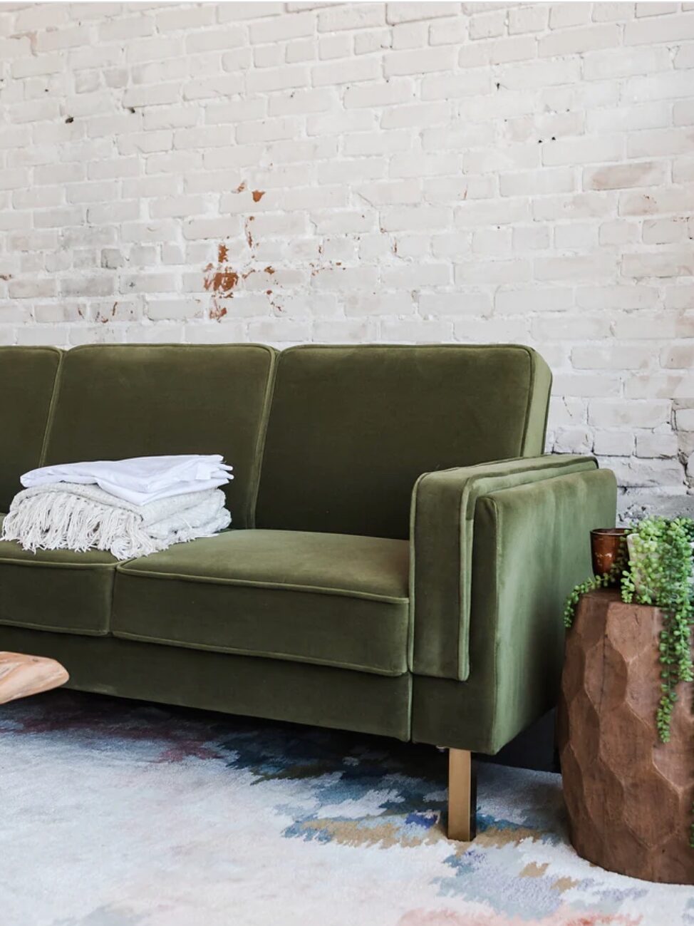 A sustainable velvelt green sofa from Albany Park