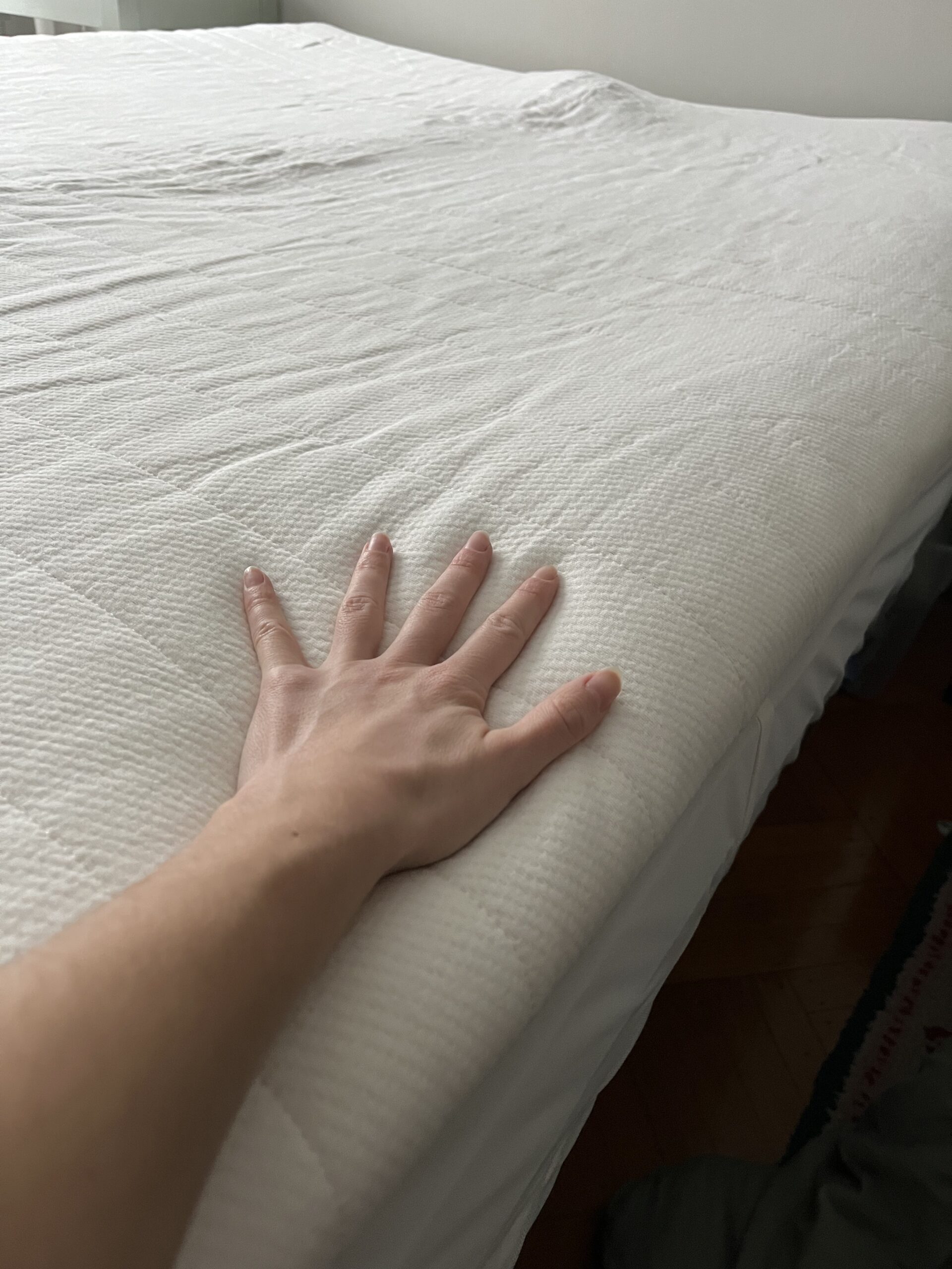 Our editor testing the mattress topper from Earthfoam