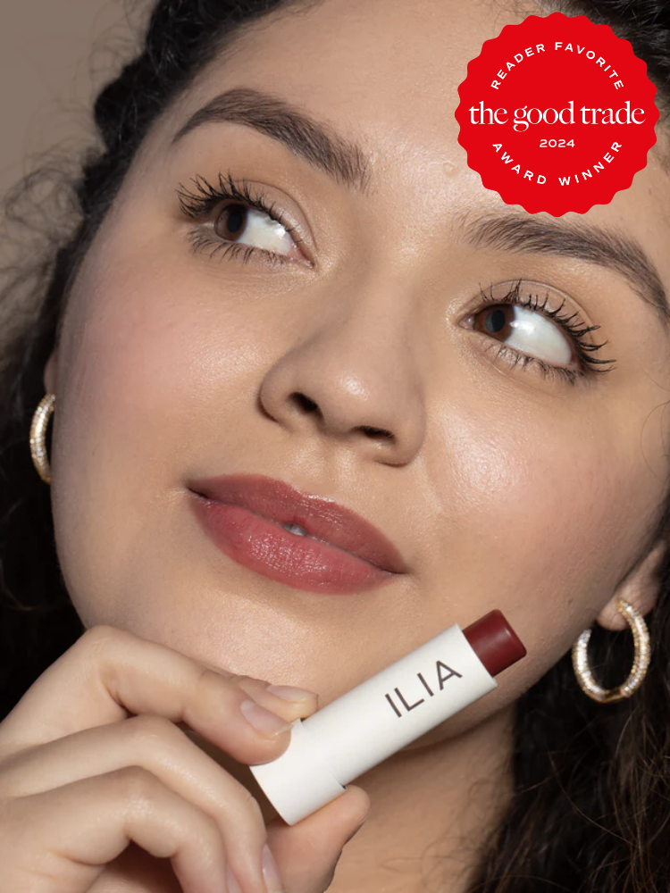 A model wearing ILIA's balmy lip tint. The TGT 2024 Award Winner Badge is on the right corner of the image. 