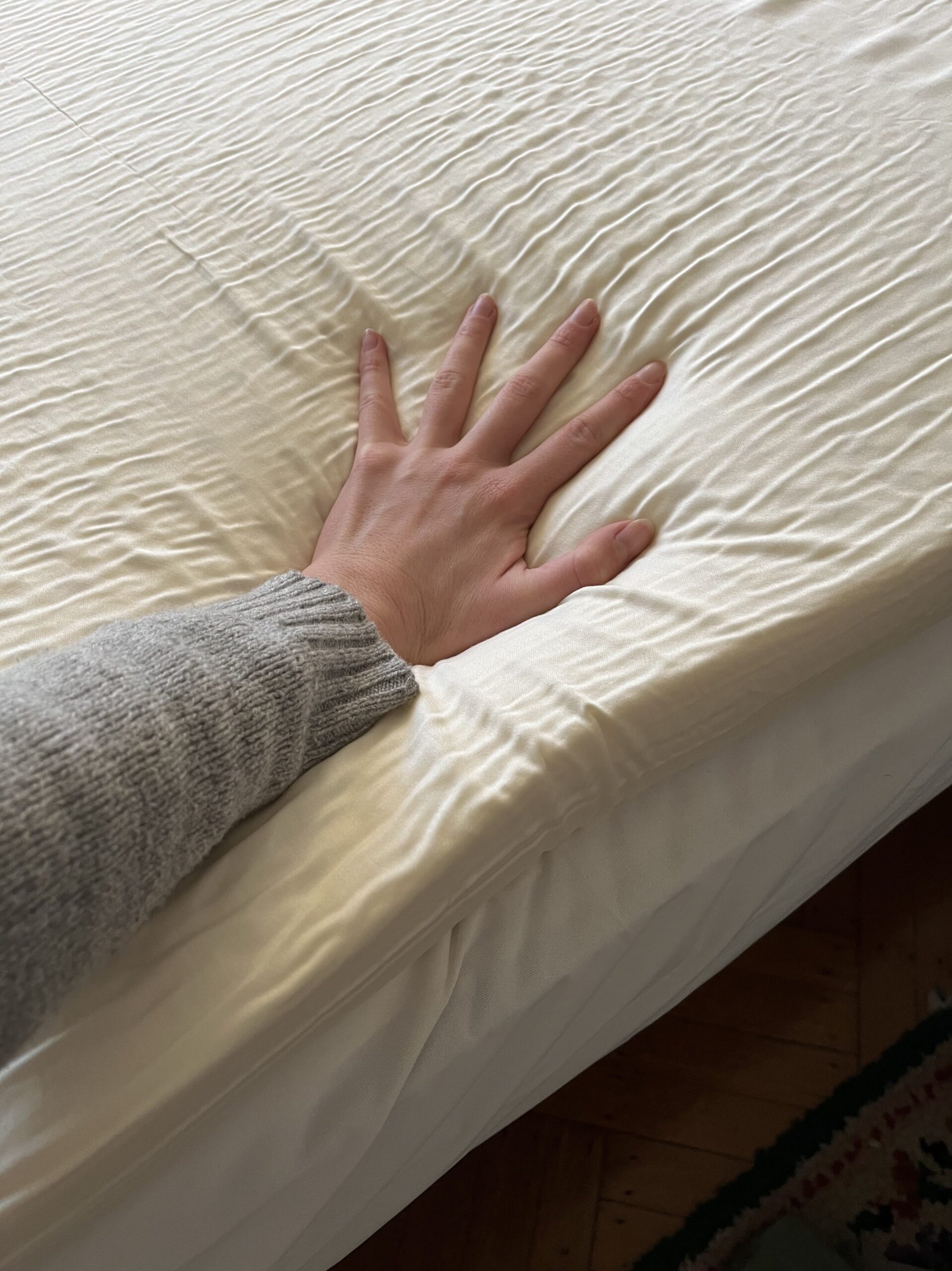 Our editor testing the mattress topper from Silk & Snow