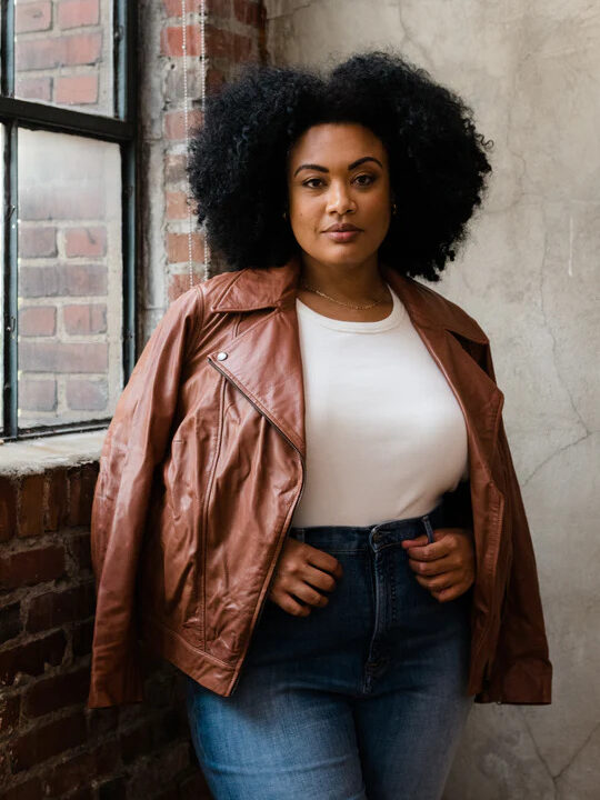 A model wearing a brown leather jacket from ABLE.