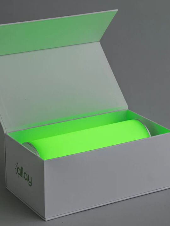 An open box with an allay lamp inside. 