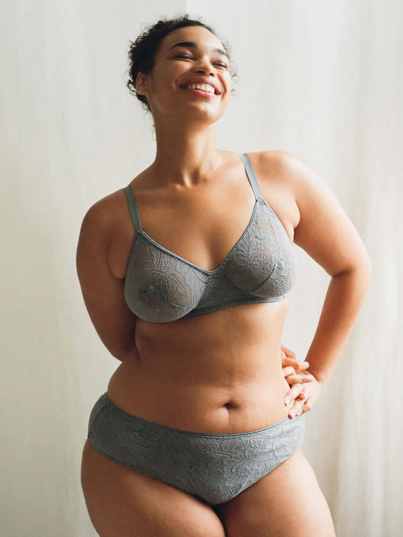 A model wearing a grey two piece organic lingerie set from Araks. 