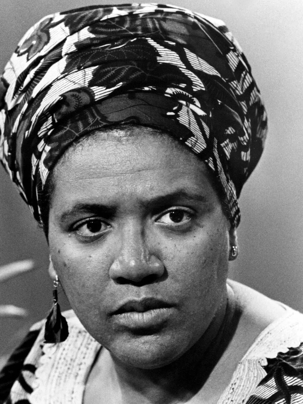 A black and white portrait of Audre Lorde.