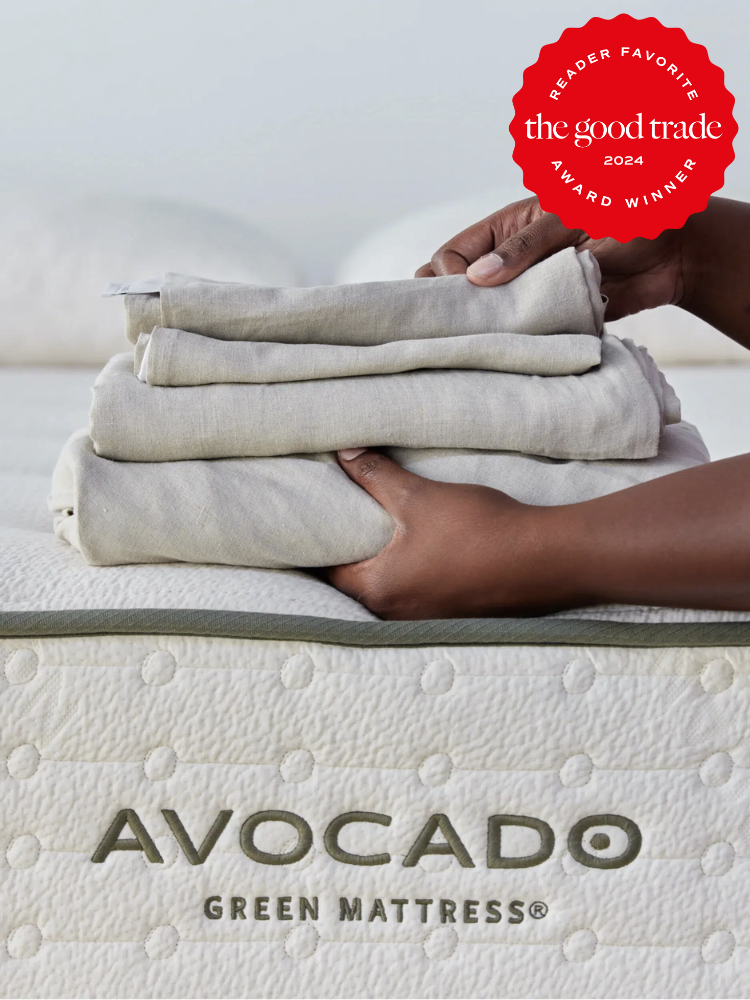 A stack of cooling sheets from Avocado being held on a mattress. The TGT 2024 Award Winner Badge is on the right corner of the image. 