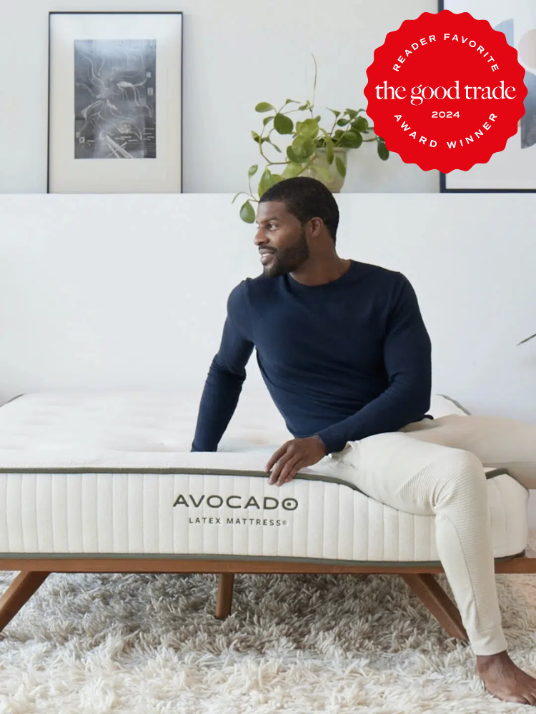 A model sits on an Avocado memory foam mattress. The TGT 2024 Award Winner Badge is on the right corner of the image.