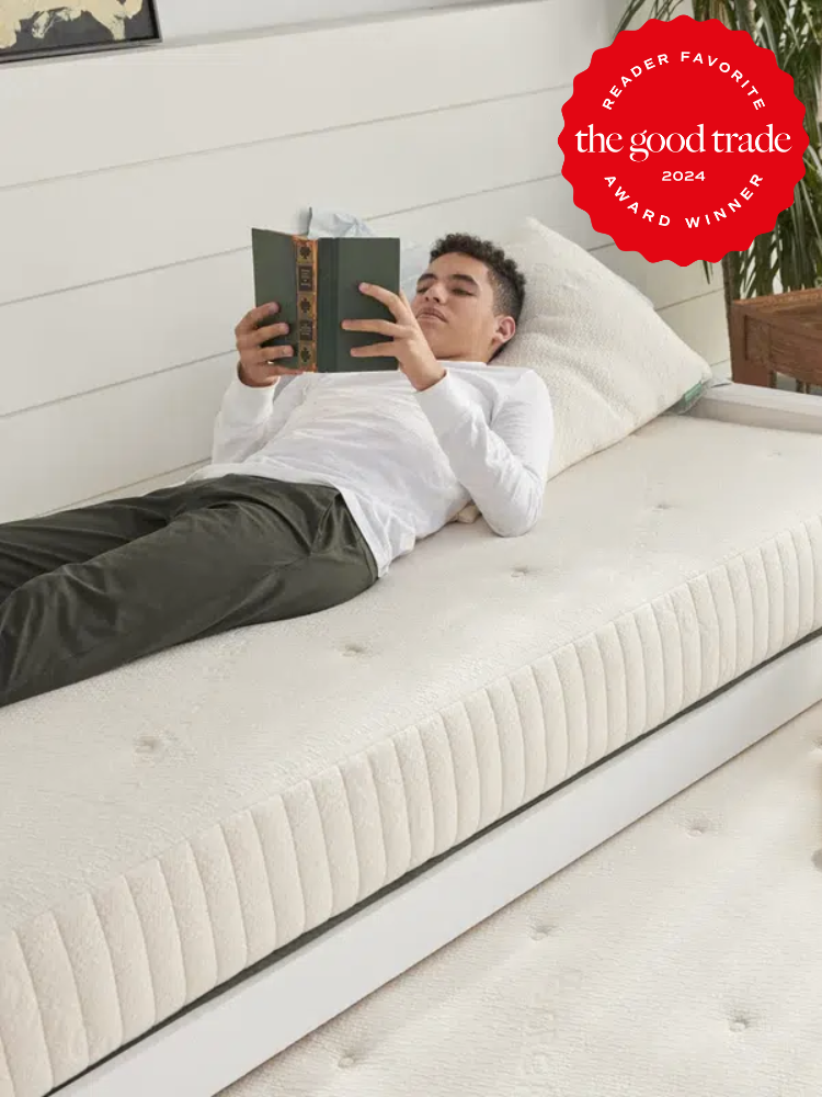 A model lays on an Avocado twin mattress, reading. The TGT Reader Award 2024 is in the top right corner. 