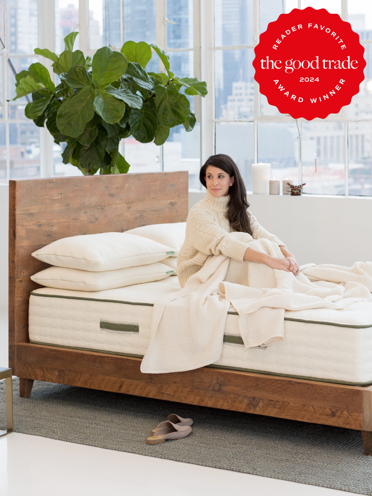 A model on an Avocado wooden bed frame. The TGT 2024 Award Winner Badge is on the right corner of the image.
