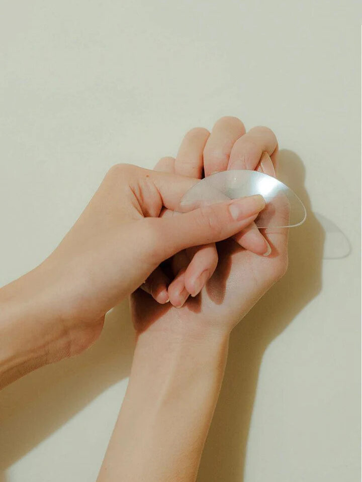 A model buffing their nails with the glass buffer from Bare Hands. 