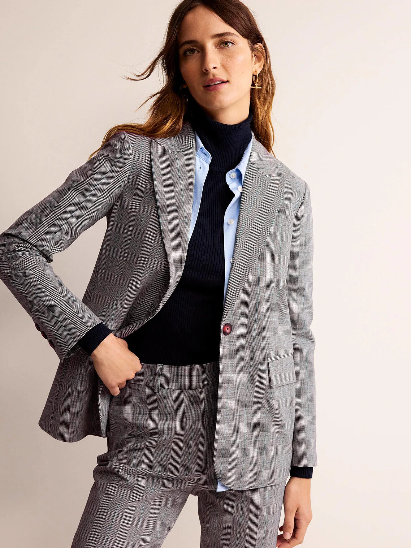 A model wearing a matching grey blazer and dress pants from Boden.