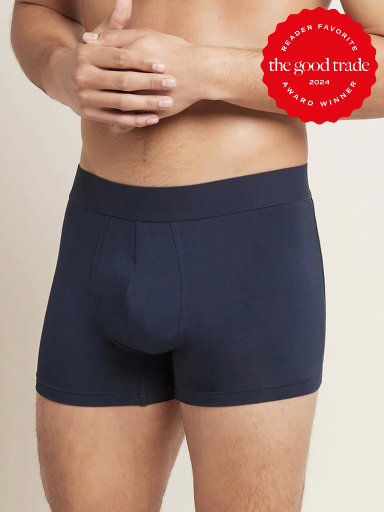 A close up shot of a model wearing blue boxers from Boody. The TGT 2024 Award Winner Badge is on the right corner of the image.