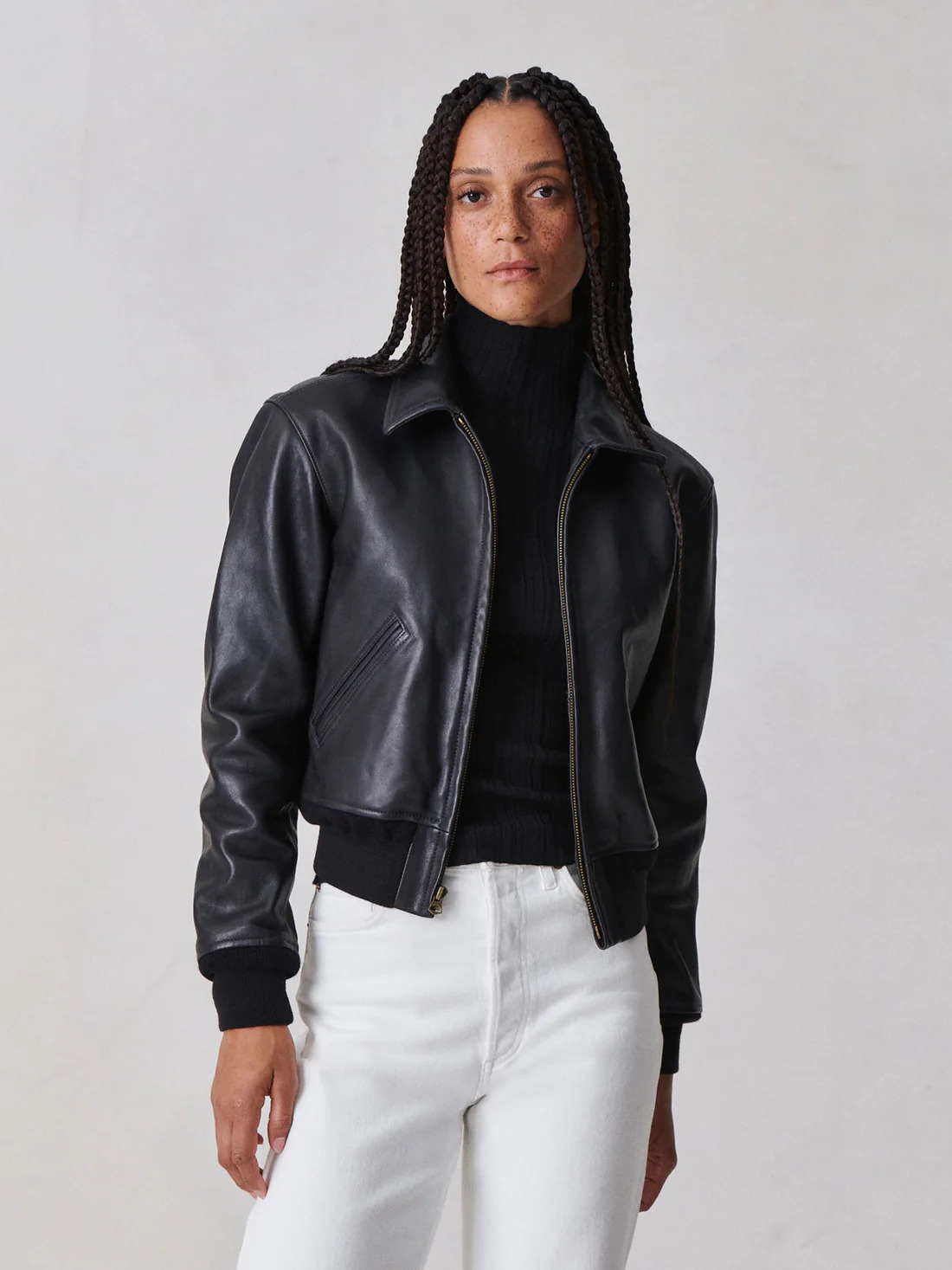 A model wearing a leather bomber jacket from Buck Mason.