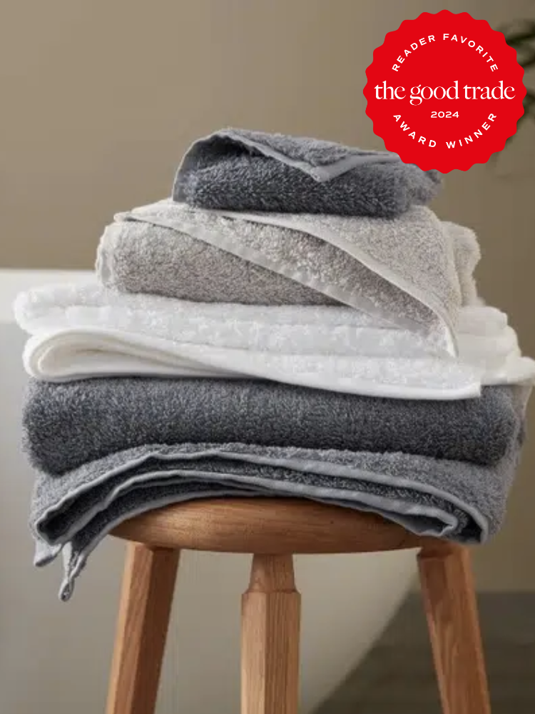 A stack of coyuchi bath towels on a stool. The TGT 2024 Award Winner Badge is on the right corner of the image. 