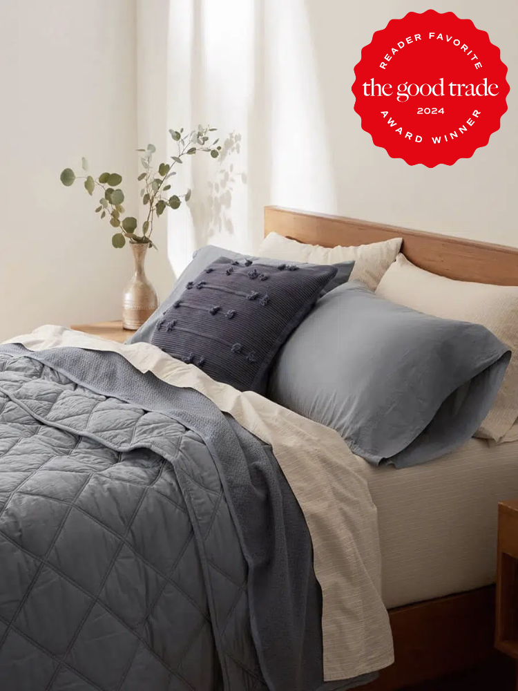 Blue Coyuchi comforter styled on a bed. The TGT 2024 Award Winner Badge is on the right corner of the image.