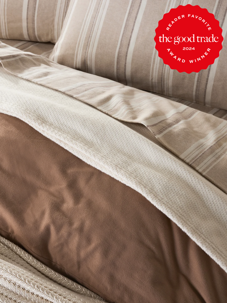Solid brown and beige and white striped bed sheets from Coyuchi. The TGT 2024 Award Winner Badge is on the right corner of the image. 
