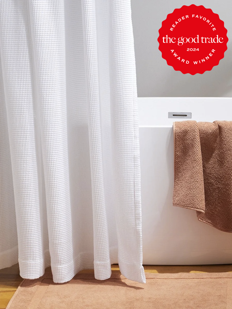 White waffle shower curtains from Coyuchi. The TGT 2024 Award Winner Badge is on the right corner of the image. 
