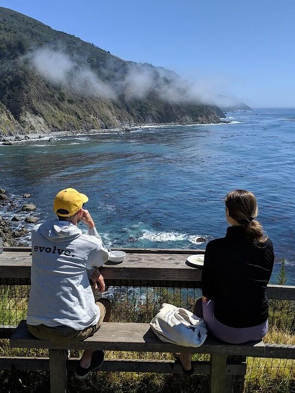 A couple looking out to the ocean at Esalen Institute.