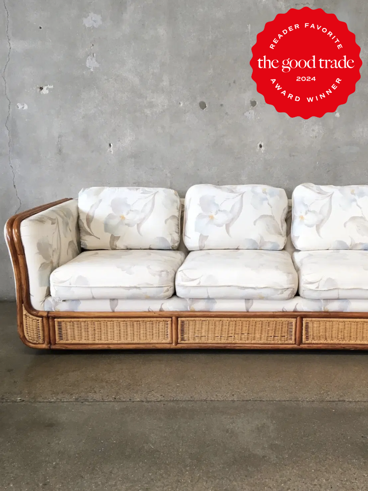 A white vintage couch with grey flowers. The TGT 2024 Award Winner Badge is on the right corner of the image.