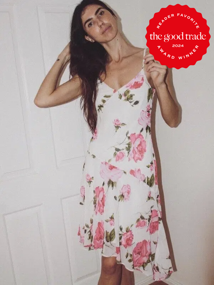A model wearing a white floral dress, thrifted from Etsy. The TGT 2024 Award Winner Badge is on the right corner of the image.