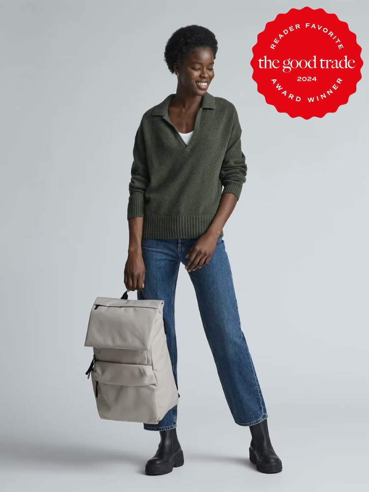 A model holds the Everlane ReNew Transit Backpack by its handles. The TGT 2024 Award Winner Badge is on the right corner of the image.