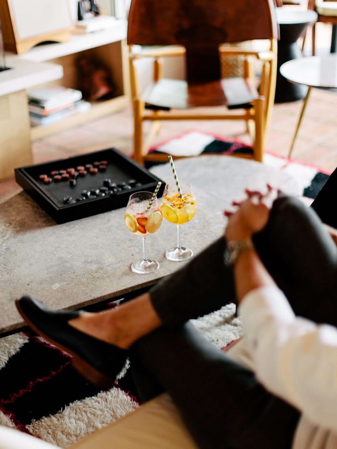 A coffee table with a board game and two glasses of Sangria at Hotel Joaquin. 