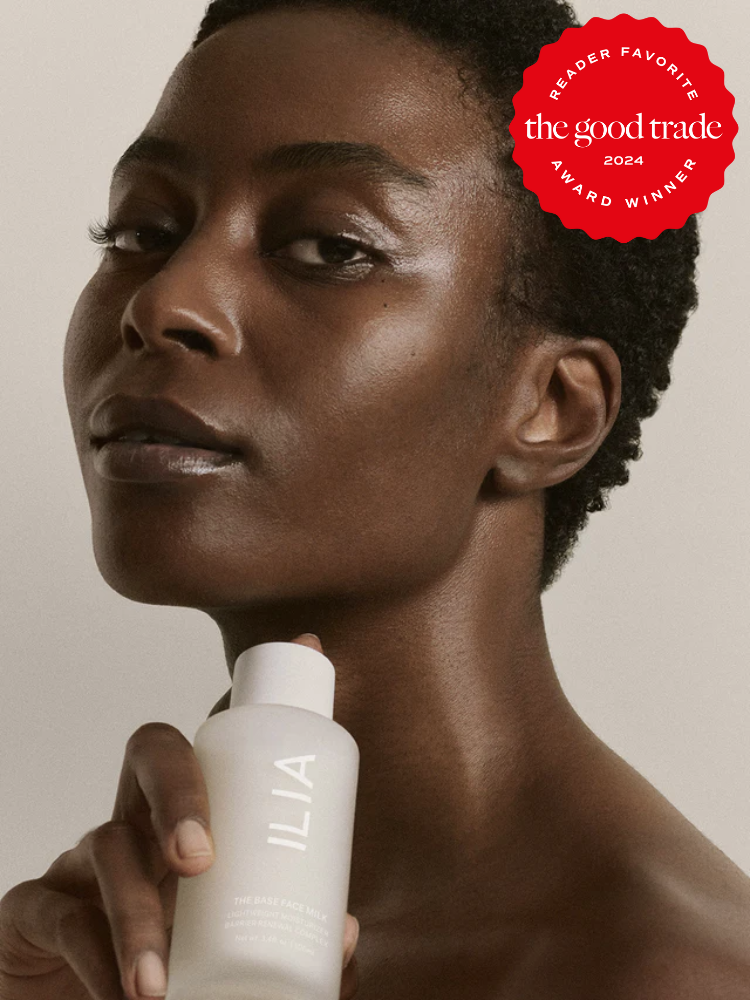 A model holding a bottle of ILIA The Base Face Milk. The TGT 2024 Award Winner Badge is on the right corner of the image.