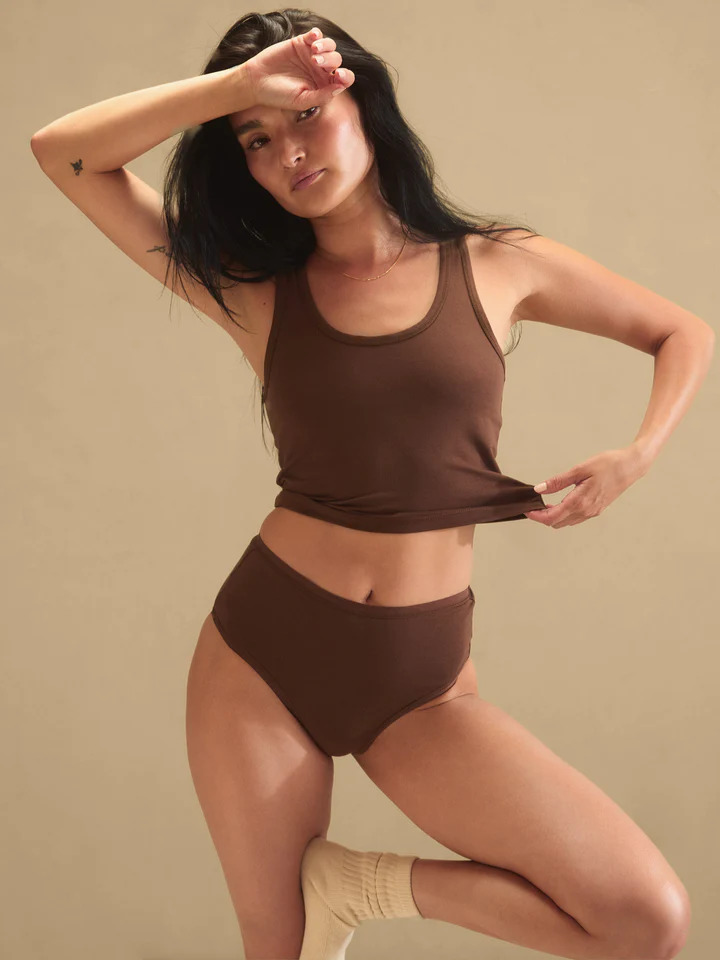 A model wearing a matching brown tank and organic underwear from Mate the Label. 