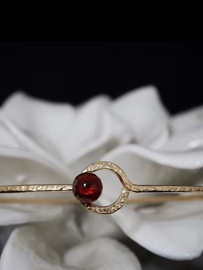 A close up shot of a red garnet bangle from Niccoletti. 