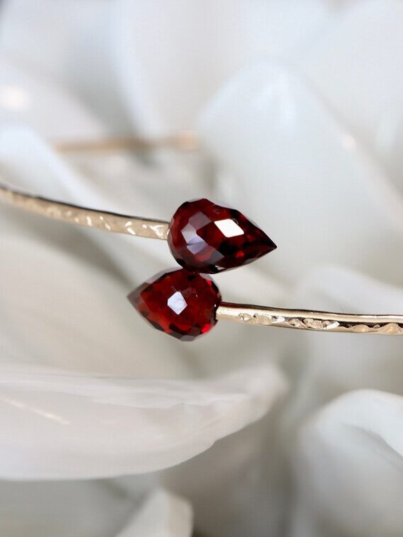 A close of shot of a double teardrop garnet bangle from Niccoletti. 