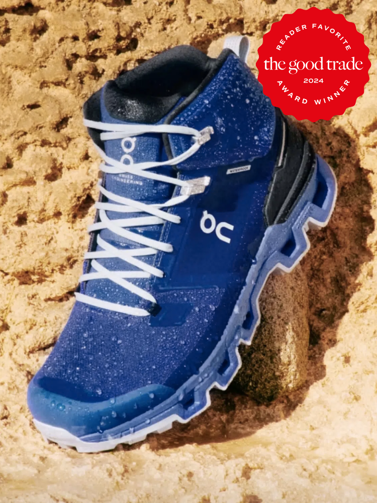 A blue On hiking boot in the sand. 