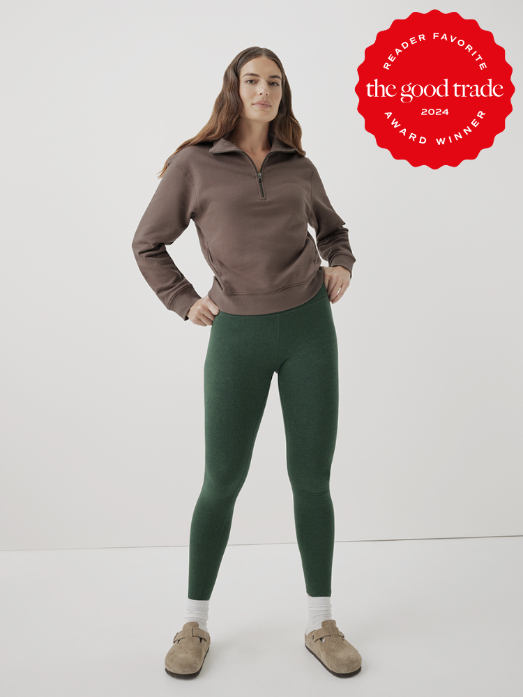 A model wears a brown half-zip turtleneck and green cotton leggings from Pact. The TGT 2024 Award Winner Badge is on the right corner of the image.
