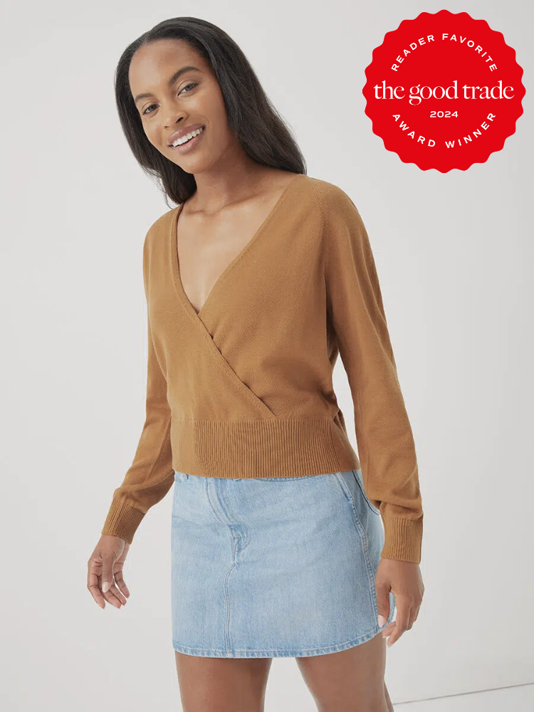 A model wearing a dark beige Fine Knit Wrap Sweater by Pact. The TGT 2024 Award Winner Badge is on the right corner of the image.