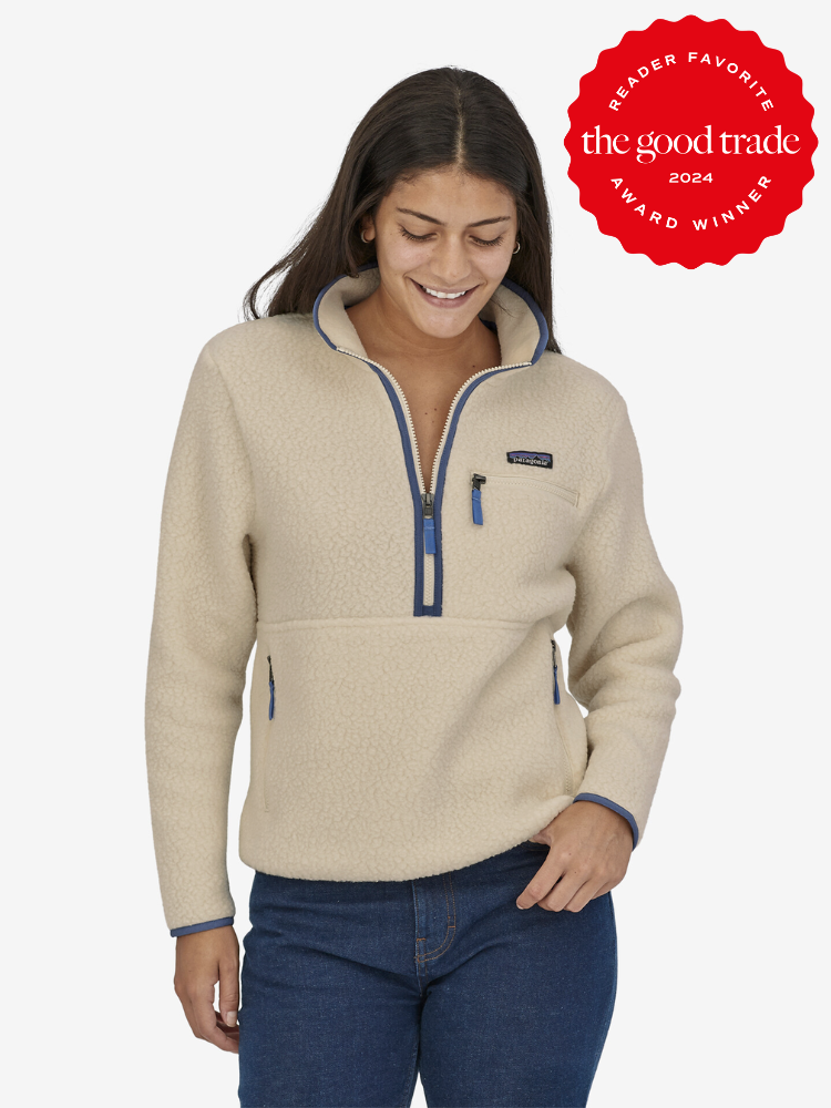 A model wearing a cream half zip fleece sweater from Patagonia.