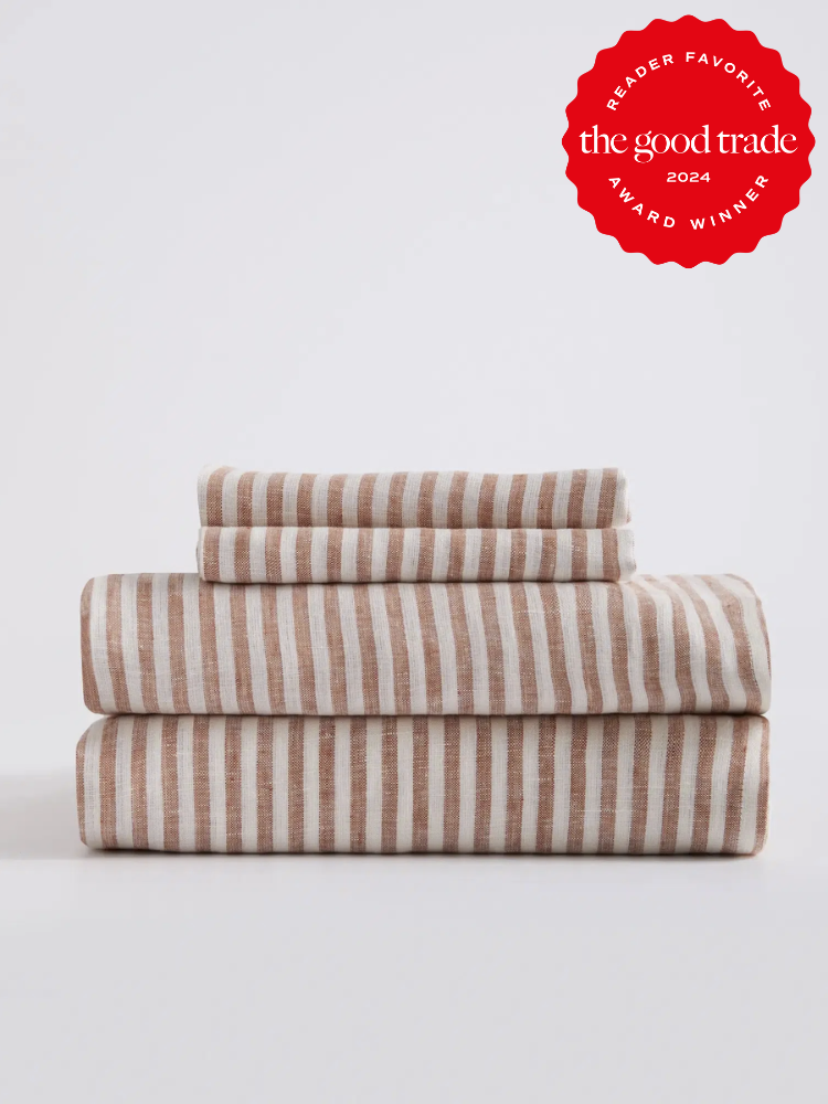 A stack of brown and white striped Quince linen sheets. The TGT 2024 Award Winner Badge is on the right corner of the image. 
