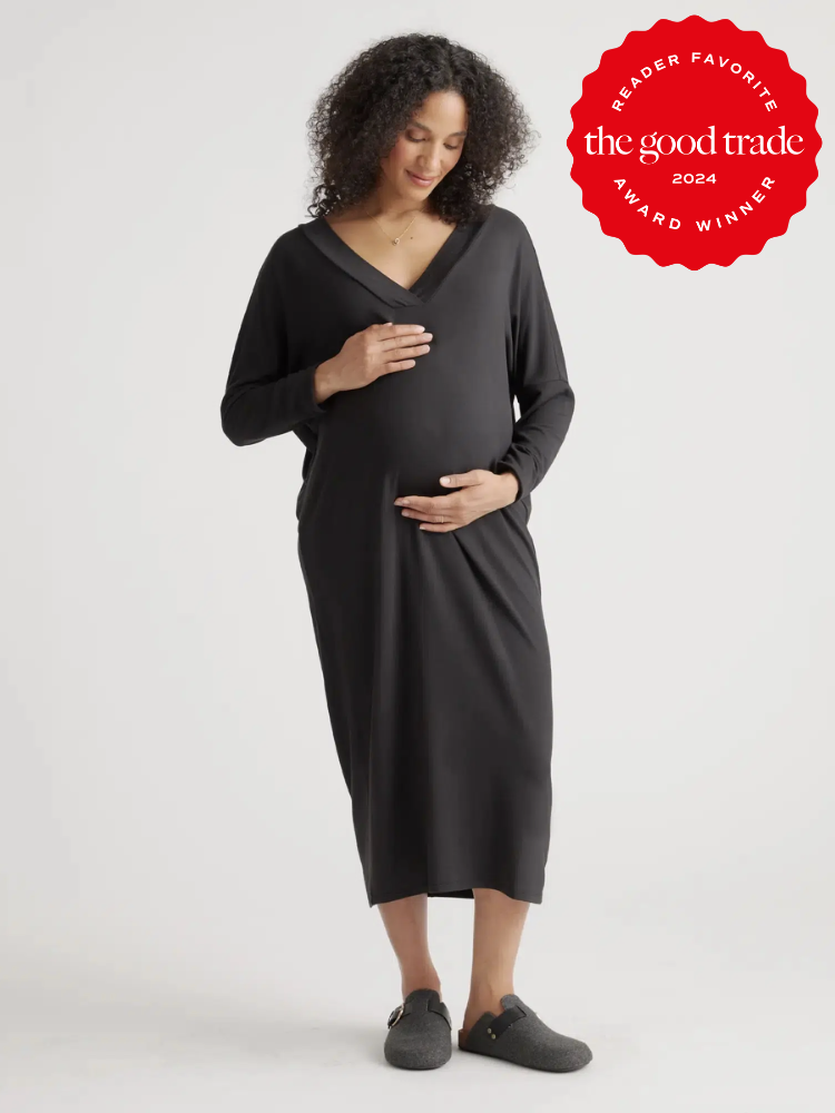 A model wears a black v-neck maternity dress from Quince. The TGT 2024 Award Winner Badge is on the right corner of the image. 