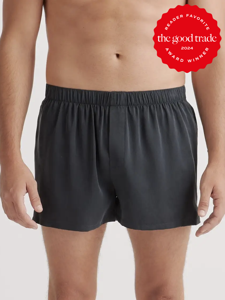 A close up shot of a model wearing black silk boxers from Quince. The TGT 2024 Award Winner Badge is on the right corner of the image.