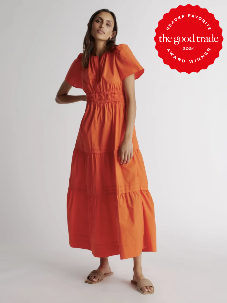 A model wearing a long orange summer dress from Quince. The TGT 2024 Award Winner Badge is on the right corner of the image.
