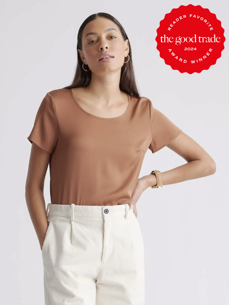 A model wearing a brown silk shirt from Quince. The TGT 2024 Award Winner Badge is on the right corner of the image. 