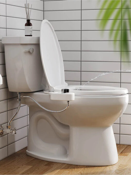A toilet with a Squatty Potty bidet attachment.