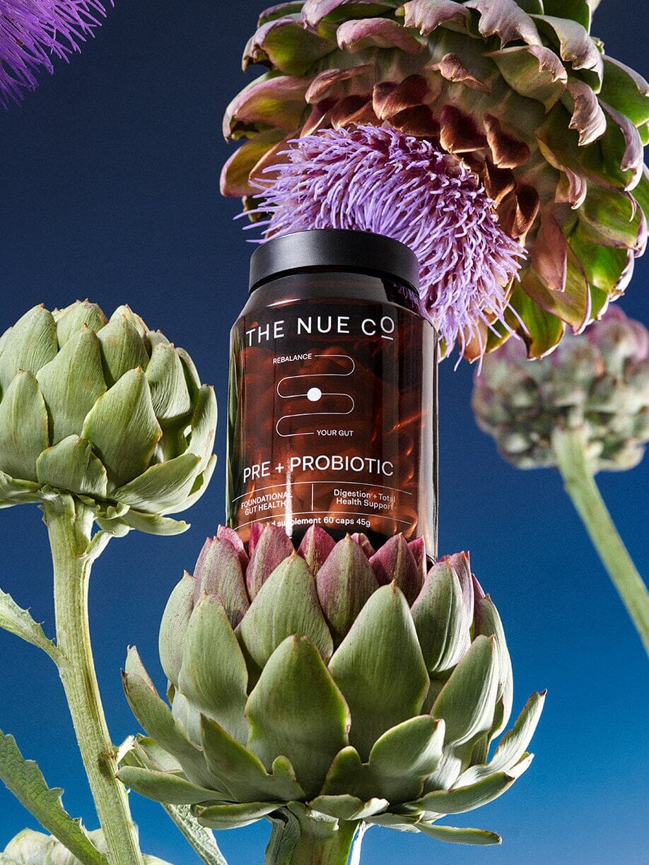 A graphic edit of The Nue Co. probiotic resting on Jerusalem artichokes.