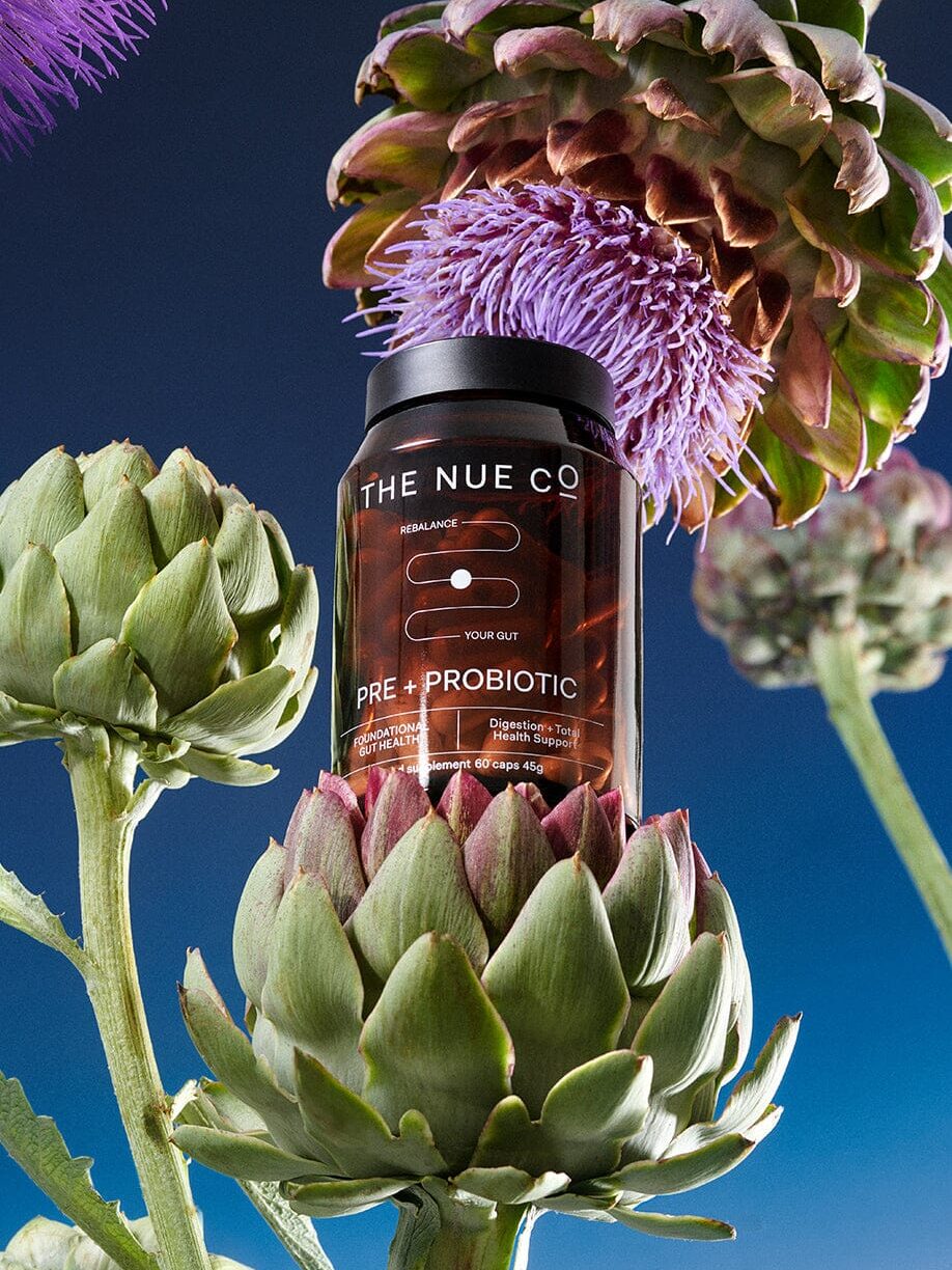 A graphic edit of The Nue Co. probiotic resting on Jerusalem artichokes. 