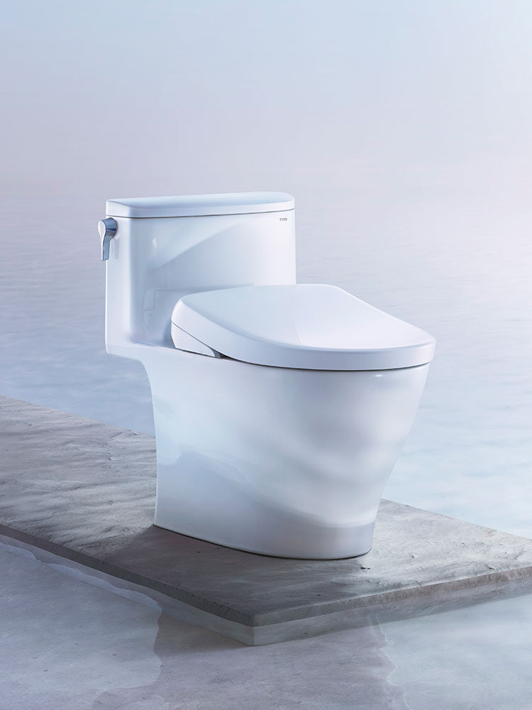 A toilet with a TOTO bidet. 