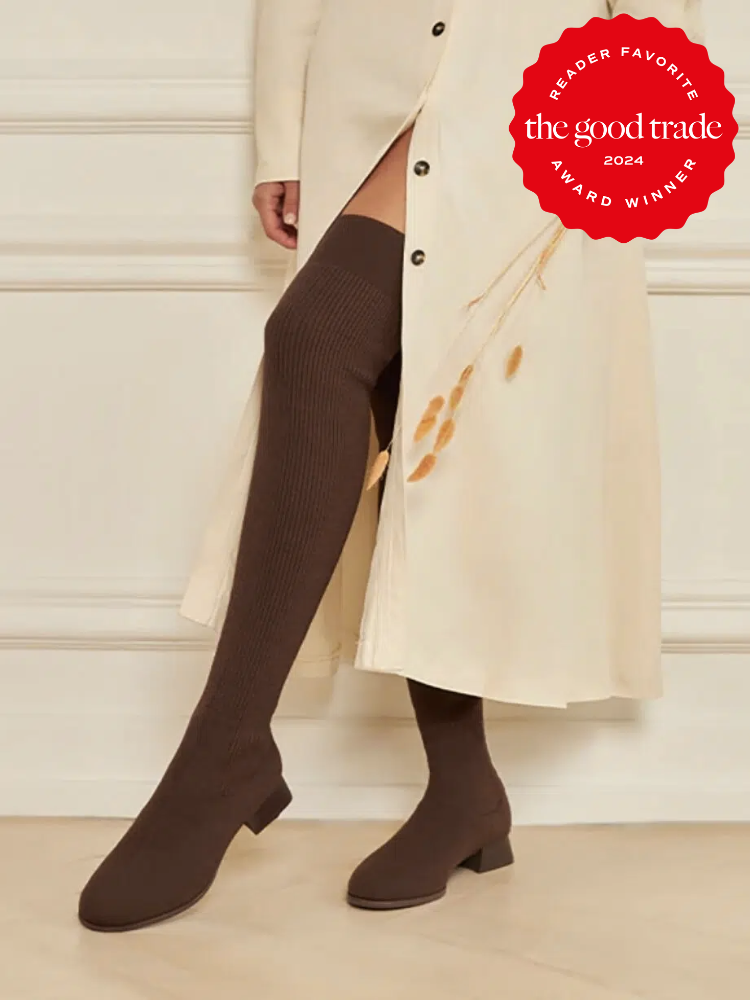 A model wearing knee high sustainable boots from Vivaia. The TGT 2024 Award Winner Badge is on the right corner of the image. 