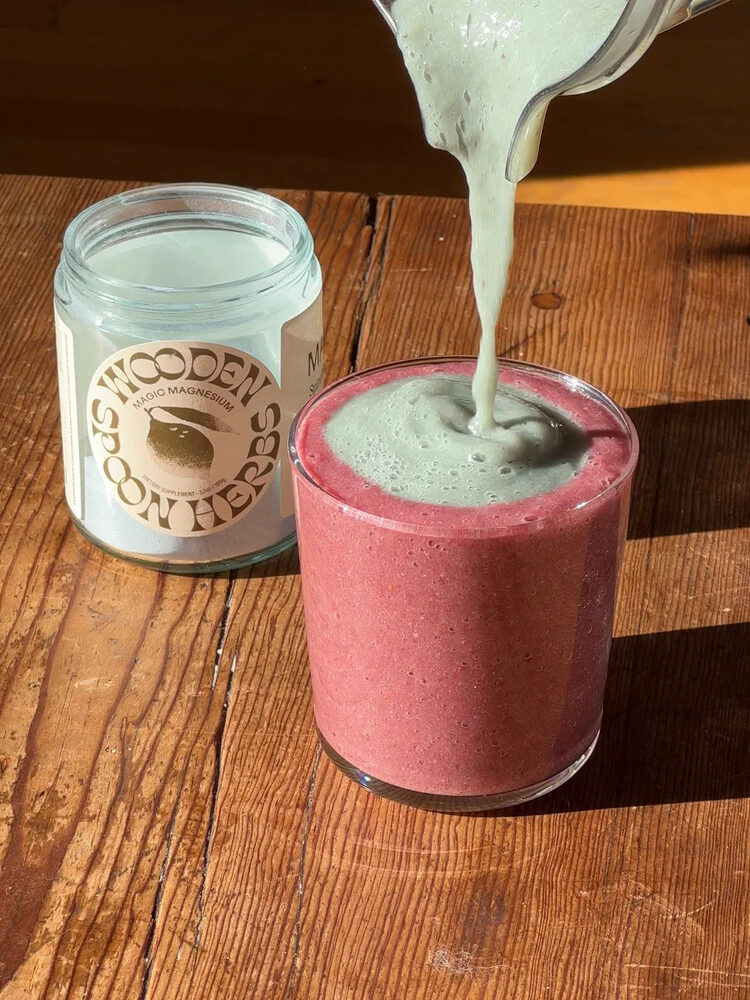 A jar of Wooden Spoon Herbs Magic Magnesium next to a smoothie. 