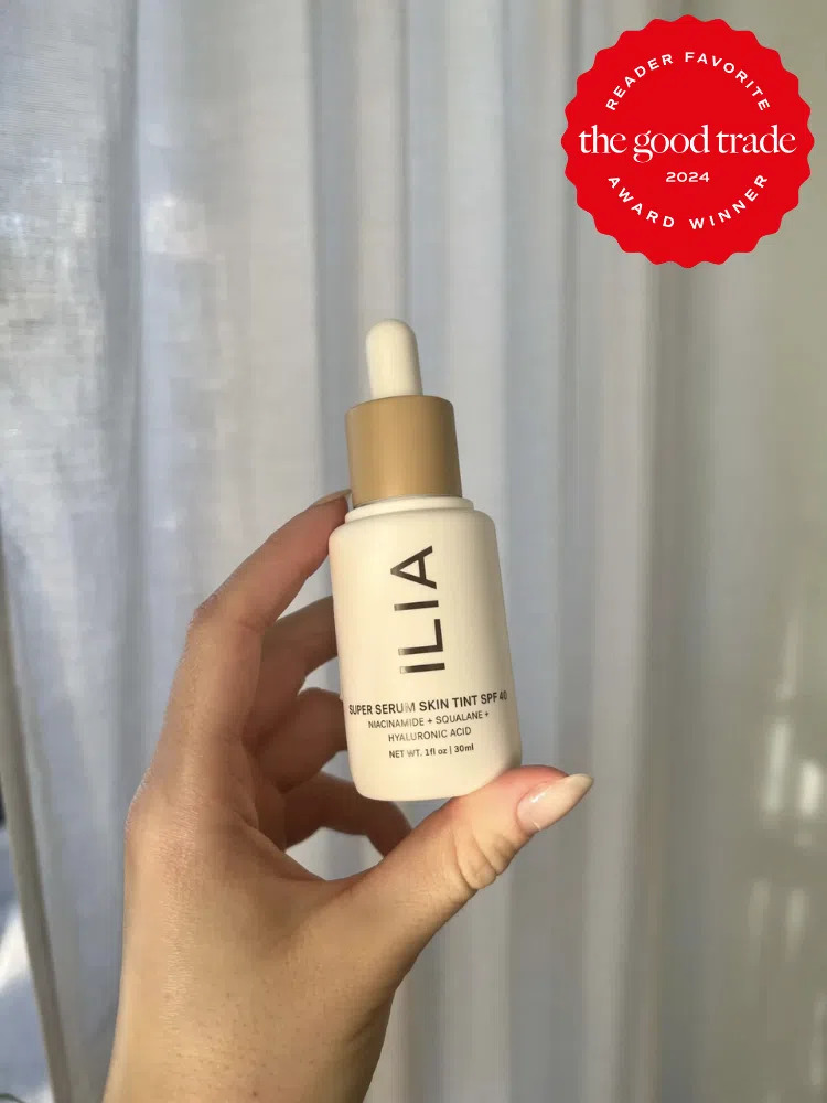A TGT Editor holding a bottle of ILIA's Skin Tint. 