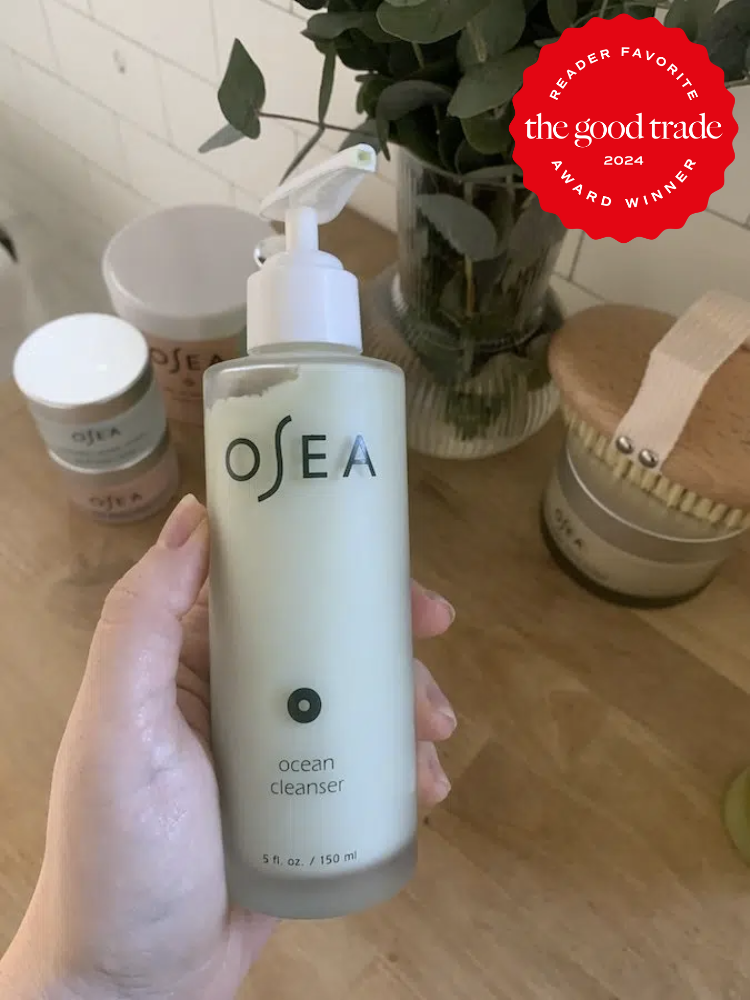 A tgt editor hlding up a bottle of OSEA's cleanser.