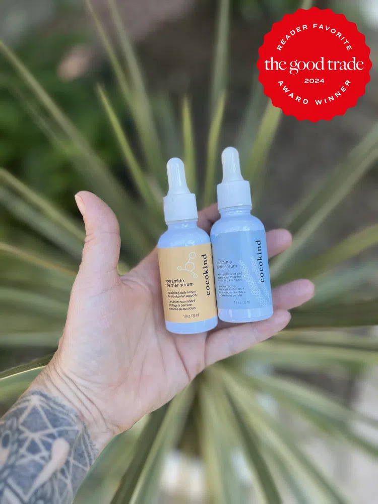 A TGT editor holding two bottles of cocokind serum. 
