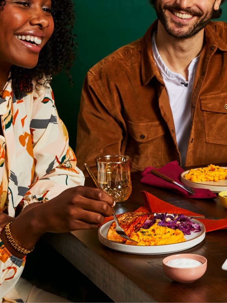 Two models sharing a meal made from a Green Chef box. 